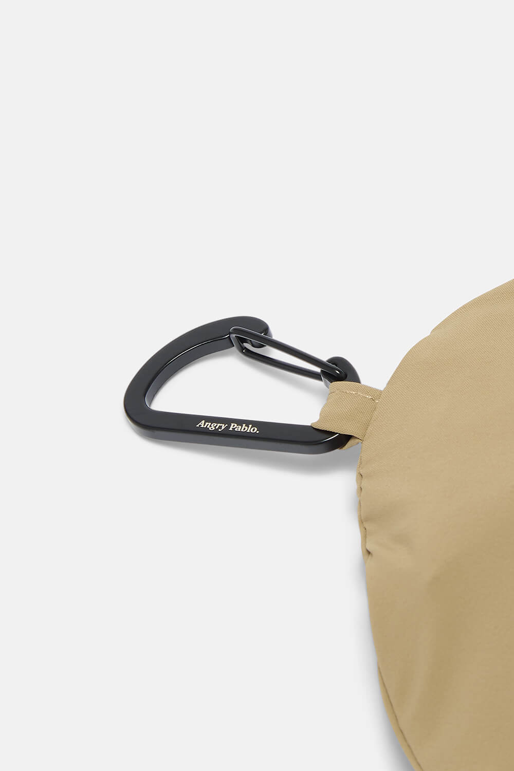 Beige bag with a black carabiner on a white background