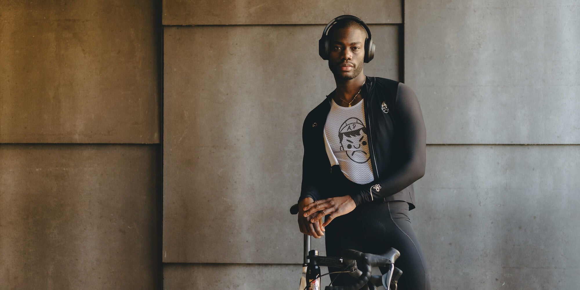 A cyclist wearing headphones and an Angry Pablo long sleeve cycling jersey