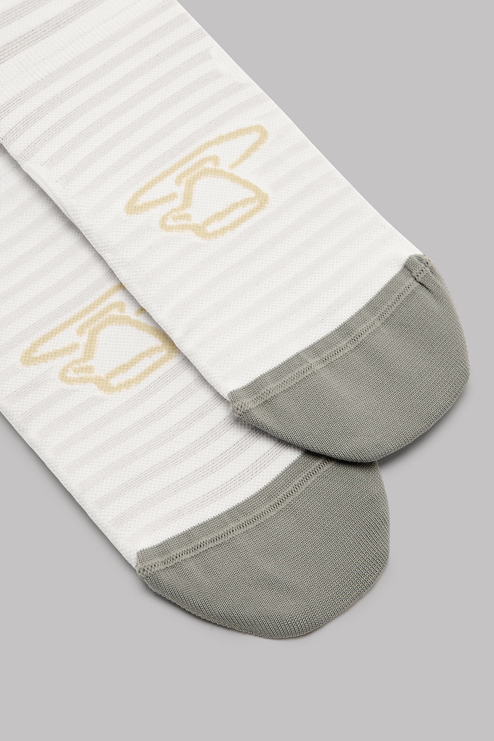 White socks with gray toes and heels on a gray background